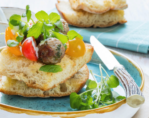 Turkish bread with minced lamb, yoghurt dressing and cherry tomatoes